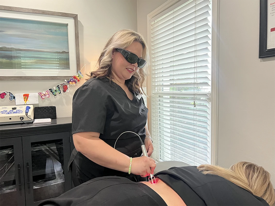 Laser Therapy Technician Treating a Patient